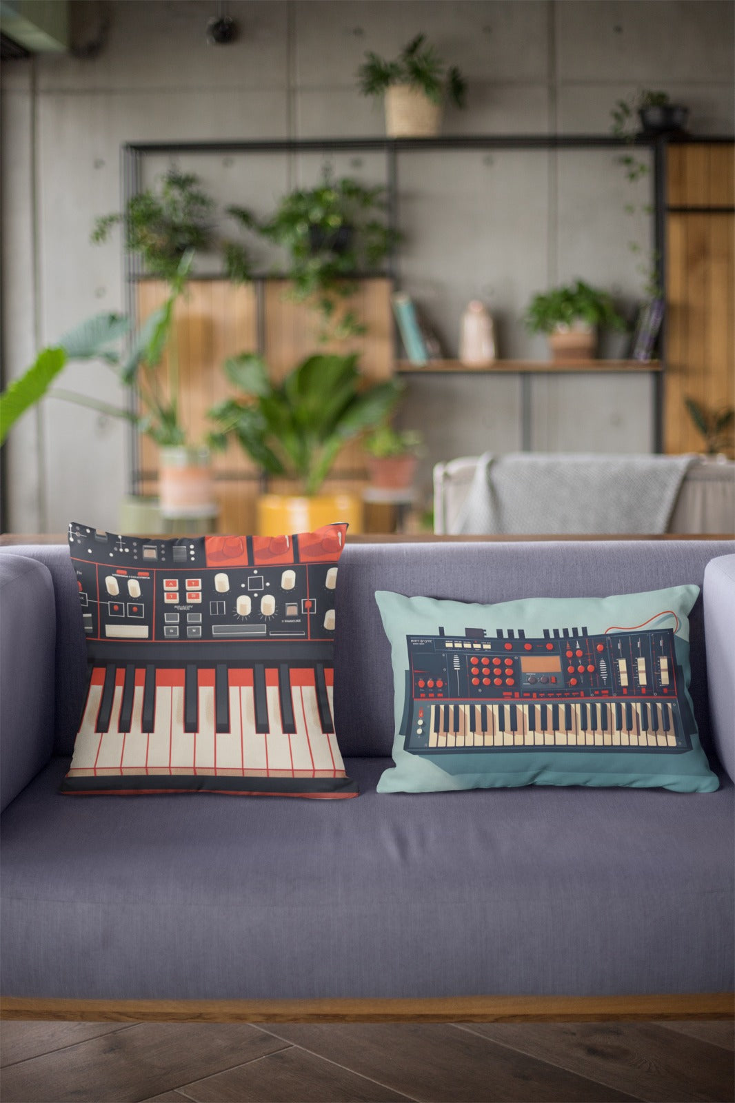 Two decorative pillows designed to resemble music production equipment, one with a keyboard and the other with a synthesizer, resting on a modern couch in a cozy living room with plants and shelves in the background.